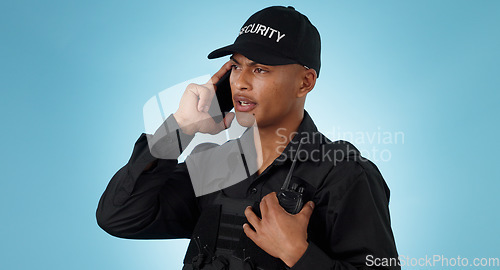 Image of Security guard, phone call and man with communication in a studio with police and law enforcement. Blue background, surveillance and officer with mobile discussion and talking for safety and danger