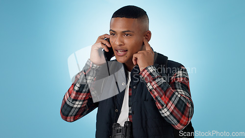 Image of Phone call, hiking and man with conversation, digital app and communication on a blue background. Person, model and hiker with a smartphone, mobile user and smile with wellness, speaking and health