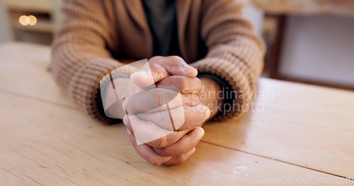 Image of Hands together, person and stress with table and problem from despair and praying. Anxiety, hope and issue in a retirement home with grief, religion and challenge at a house with worry or gratitude