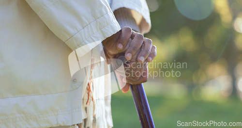 Image of Hands, walking stick and person with disability outdoor for rehabilitation, support or help in retirement. Closeup, sick senior and cane for balance of parkinson, arthritis and healthcare aid in park