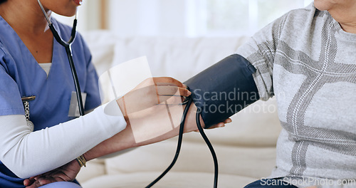 Image of Nurse hands, home and blood pressure test for healthcare service, support and caregiver for medical monitor. ADN worker or doctor with patient arm, stethoscope or helping in hypertension exam on sofa