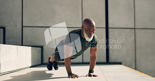 Image of Mature, man and fitness for exercise with pushup for strength, health or wellness by outside. African person, alone and training near stairs for workout with endurance, concentration and dedication