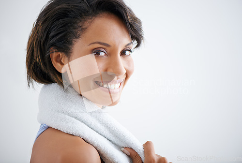 Image of Fitness, face portrait and happy woman with towel for sweat after cardio exercise, pilates practice or yoga club. Sports athlete, studio training and model smile for challenge on white background