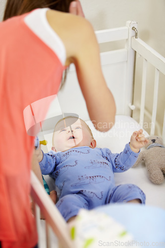 Image of Mother, baby and crib in nursery with love, bonding and playing for child development and relationship. Woman, infant or newborn in bedroom of home for bedtime, care and routine with pacifier and toy