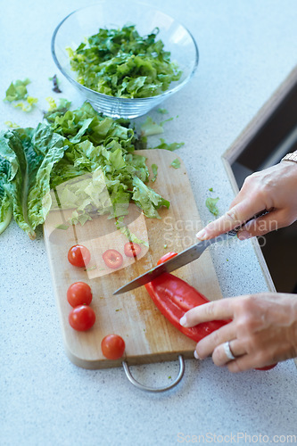 Image of Hands on chopping board, vegetables and knife on table top in kitchen cooking food. Closeup of cutting plants on counter, above and tomato, pepper and nutrition for healthy lettuce salad in home