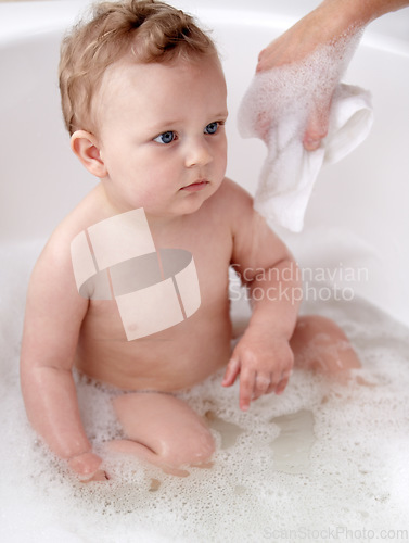 Image of Baby, bubbles and bath or water cleaning for skin or hair wash for childhood development, hygiene or soap. Child, boy and tub for relax wellness or wet in home for play or cleansing, foam or sanitary