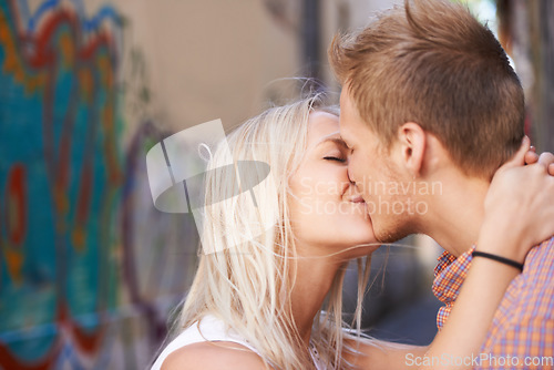 Image of Kiss, love and couple in a a city street with freedom, romance and intimacy, connection or passion. Desire, lips and people embrace in Puerto Rico for travel, journey or adventure outdoor together