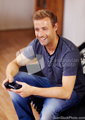 Image of Man, video game and home on sofa, controller or smile for online competition, relax or press in lounge. Gamer person, playing and idea with click for strategy, streaming or digital challenge on couch