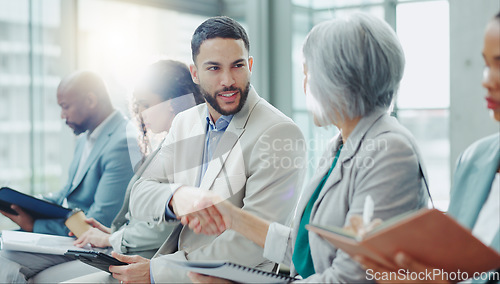 Image of Business people, handshake and meeting in seminar greeting, introduction or teamwork at office. Businessman shaking hands with woman in staff training, team workshop or recruiting deal at workplace