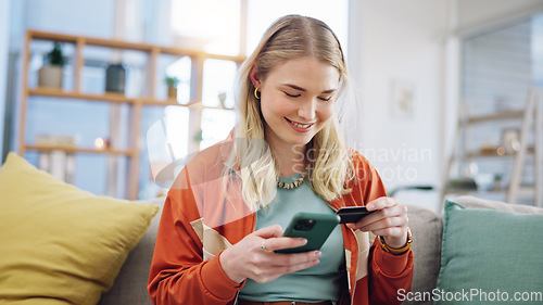 Image of Woman, credit card and phone for online shopping in home with digital payment, fintech and finance of money. Happy person on sofa for mobile banking, ecommerce and password for sales on financial app