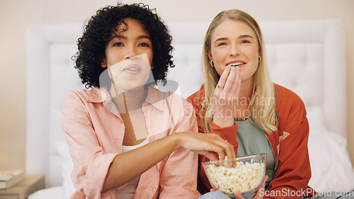 Image of Television, happy and women friends on a bed with popcorn for movie, comedy or standup show at home. Comic, snack and ladies watching tv in a bedroom laugh, bond and relax with streaming subscription