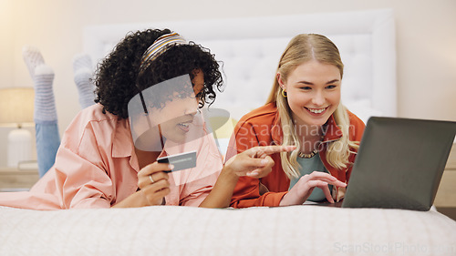 Image of Credit card, women and friends with laptop on a bed for ecommerce, sale or sign up subscribe in their home. Online shopping, payment and lady customer online in a bedroom for deal, budget or survey