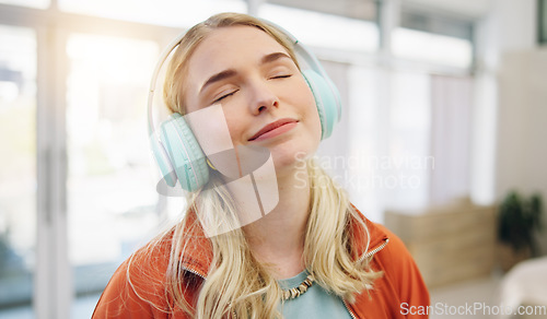 Image of Music, smile and relax with woman on sofa for streaming, happy and energy. Freedom, media and online radio with person listening to headphones in living room at home for technology, sound and audio