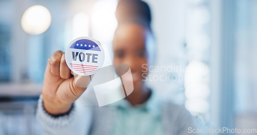 Image of Hand, vote and badge with a black woman in government for support or motivation of a political campaign. Portrait, smile and democracy with a happy voter holding her pin of choice in a party election