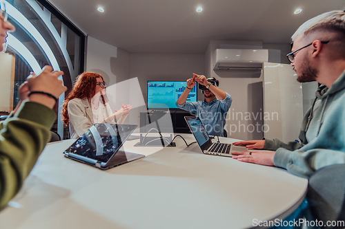 Image of A diverse group of businessmen collaborates and tests a new virtual reality technology, wearing virtual glasses, showcasing innovation and creativity in their futuristic workspace