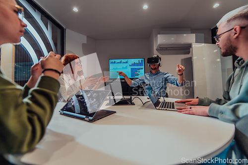 Image of A diverse group of businessmen collaborates and tests a new virtual reality technology, wearing virtual glasses, showcasing innovation and creativity in their futuristic workspace