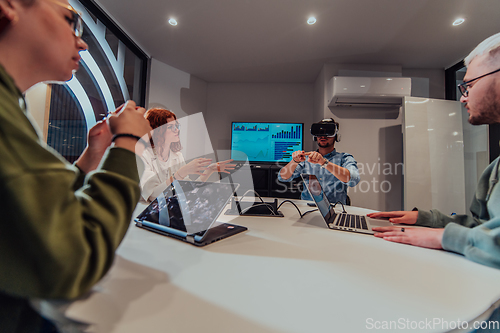 Image of A diverse group of businessmen collaborates and tests a new virtual reality technology, wearing virtual glasses, showcasing innovation and creativity in their futuristic workspace