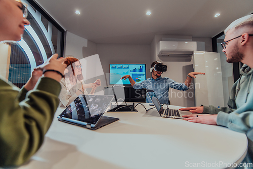 Image of A diverse group of businessmen collaborates and tests a new virtual reality technology, wearing virtual glasses, showcasing innovation and creativity in their futuristic workspace