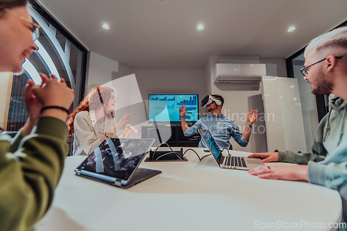 Image of A diverse group of businessmen collaborates and tests a new virtual reality technology, wearing virtual glasses, showcasing innovation and creativity in their futuristic workspace