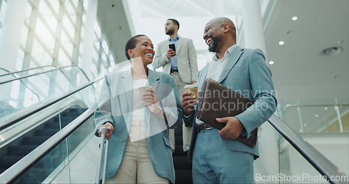 Image of Happy business people, coffee and laughing on escalator for funny joke, discussion or morning at airport. Businessman and woman smile with latte or cappuccino down a moving staircase for work travel