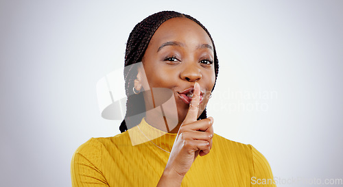 Image of Secret, woman and portrait with finger on lips in studio for sign of privacy, confidential deal and surprise on white background. Face of african model show quiet emoji for gossip, news and whisper