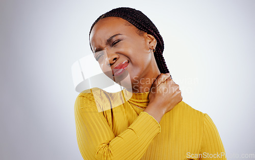 Image of Woman, neck pain and stress or injury, studio and inflammation by gray background or tired. Black female person, frustrated and joint or muscle arthritis, massage and strain or tension of nerve