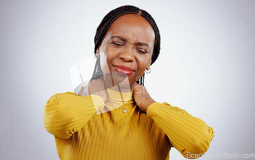 Image of Woman, neck pain and stress or frustrated, studio and inflammation by gray background or tired. Black female person, injury and joint or muscle arthritis, massage and strain or tension of nerve