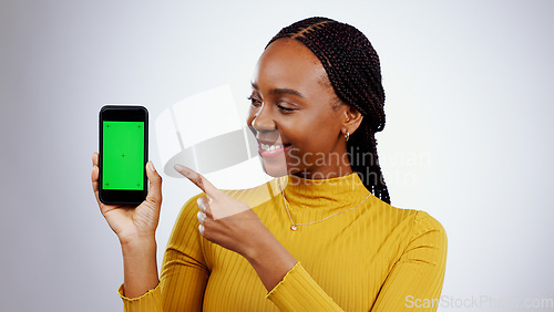 Image of Woman, phone and green screen for presentation mockup, marketing and happy news on a white background. Young african person on mobile app, space and opportunity with tracking marker in studio