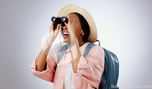 Image of Woman, binoculars and search on adventure, studio and travel or backpack by gray background. Black person, vacation and holiday in mockup, watch and explore on journey, gear and equipment for tourist