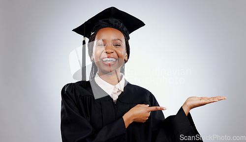 Image of Graduate, black woman and portrait with pointing to college deal and academy promotion in studio. Happy, university student and school marketing with white background and African person with study