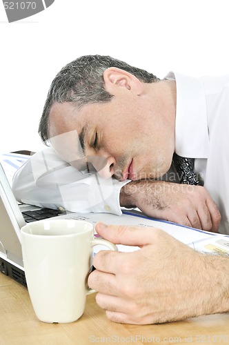Image of Businessman asleep at his desk on white background