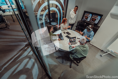 Image of A diverse group of businessmen collaborates and tests a new virtual reality technology, wearing virtual glasses, showcasing innovation and creativity in their futuristic workspace