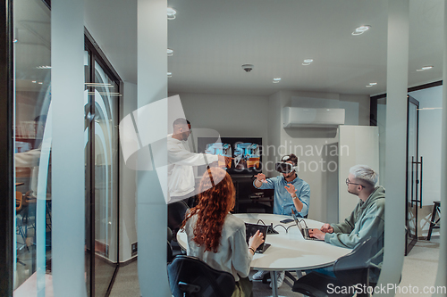 Image of A diverse group of businessmen collaborates and tests a new virtual reality technology, wearing virtual glasses, showcasing innovation and creativity in their futuristic workspace