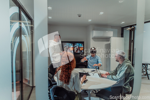 Image of A diverse group of businessmen collaborates and tests a new virtual reality technology, wearing virtual glasses, showcasing innovation and creativity in their futuristic workspace