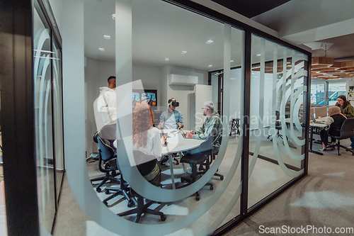 Image of A diverse group of businessmen collaborates and tests a new virtual reality technology, wearing virtual glasses, showcasing innovation and creativity in their futuristic workspace