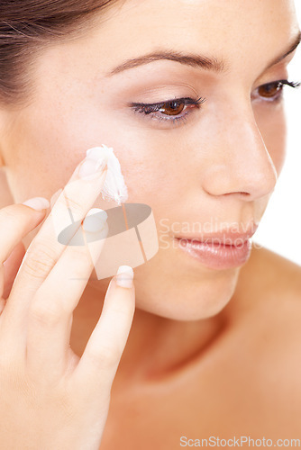 Image of Face cream, application and woman in studio for skincare, wellness or cosmetics closeup. Facial, sunscreen and female model with luxury skin product, lotion or spf, anti aging and collagen treatment