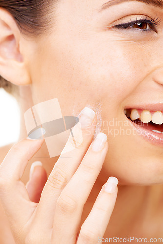 Image of Happy woman, face and hands with cream for skincare, beauty or cosmetics against a studio background. Closeup of female person or model smile in satisfaction for lotion, creme or facial product