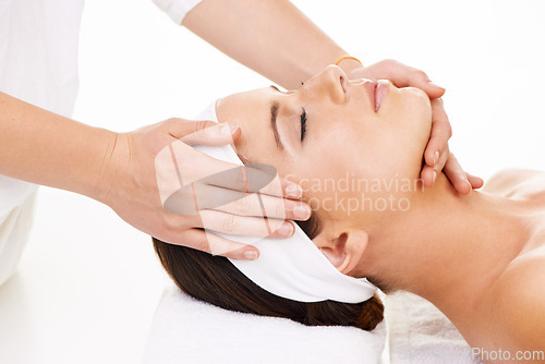 Image of Spa, hands and face massage with a woman customer in studio isolated on a white background for stress relief. Head, luxury treatment and a young person at the salon for health, wellness or to relax
