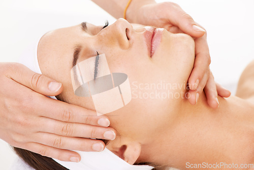 Image of Head, hands and massage with a woman customer in studio isolated on a white background for stress relief. Spa, luxury face treatment and a young person at the salon for health, wellness or to relax