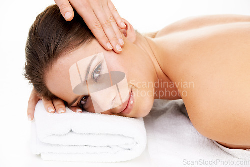 Image of Portrait, massage and beauty with a woman at the spa in studio isolated on a white background to relax. Hands, face and head with a happy young salon customer on a table for luxury wellness treatment