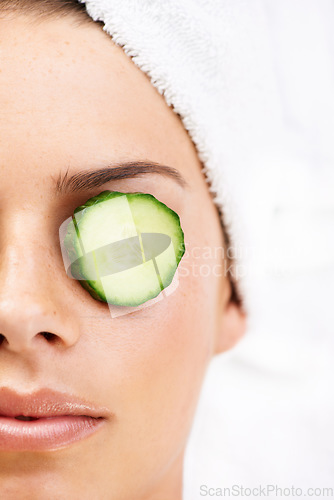 Image of Woman, face and cucumber on eye for wellness, cosmetic or spa therapy with closeup, relax and peace. Person, skincare or detox treatment for beauty, skin or stress relief and relaxation or wellbeing