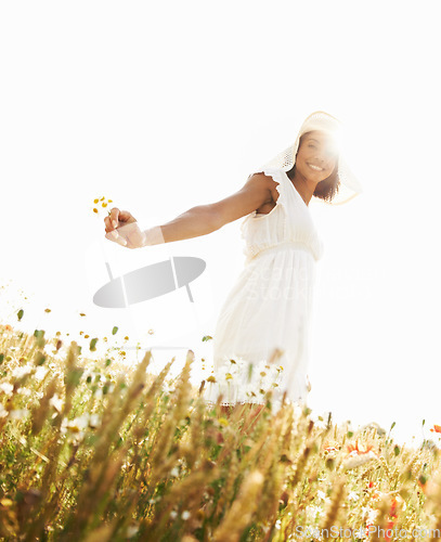 Image of Portrait, smile and woman in field with flowers in the countryside in summer. Happy person in hat, nature and wheat farm or garden on lens flare, mockup and travel on holiday or vacation in Brazil