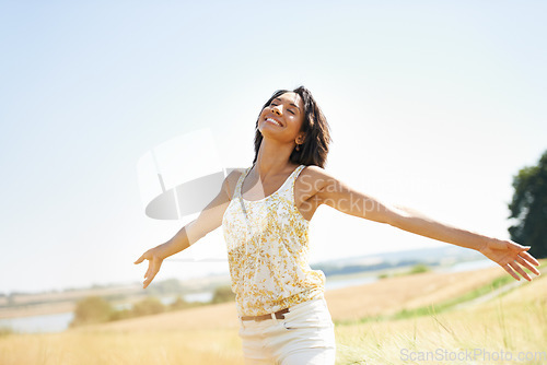 Image of Happy, freedom and woman with arms raised at field outdoor in the countryside in spring. Person in nature, eyes closed and relax at farm, breathe fresh air or enjoy vacation, travel and peace or calm