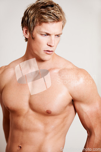 Image of Man, topless and muscle for thinking in studio or white background, confidence or bodybuilder chest. Male person, model and masculine abs for strength or flexing pose or attractive, strong in Norway