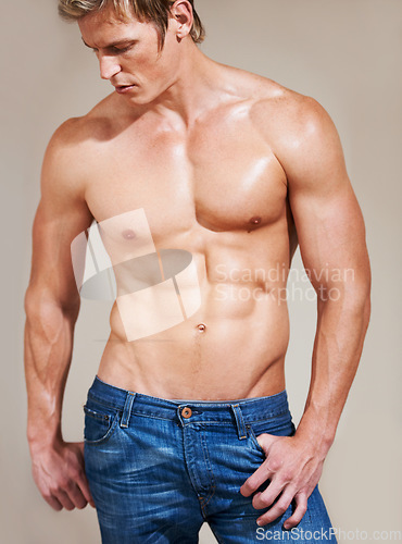 Image of Man, bodybuilder and muscle with abs, sexy and shirtless for body, strong and model in studio background. Athlete, workout and topless for six pack, chest and fit for health, exercise and training