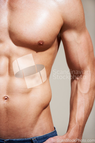 Image of Bodybuilder, strong and muscle with stomach, sexy and shirtless for body, six pack and model in studio background. Athlete, workout and wellness for abs, chest or fit for health, exercise or training