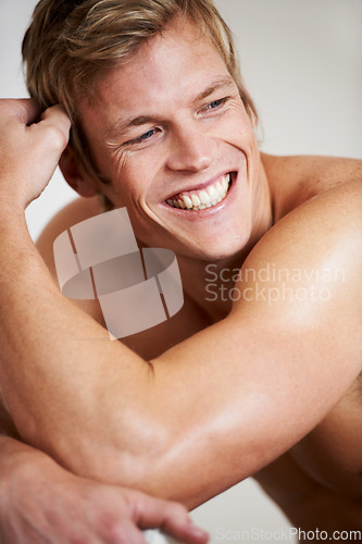 Image of Face, smile and a shirtless man closeup in studio isolated on a gray background for heath or fitness. Skin, body and a happy young model looking satisfied with exercise or training for wellness