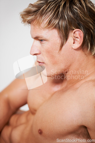 Image of Man, topless and muscle in studio or white background for confident masculine, strong body or bodybuilder pride. Male person, model and shirtless for bicep arms or shoulders, attractive in Norway