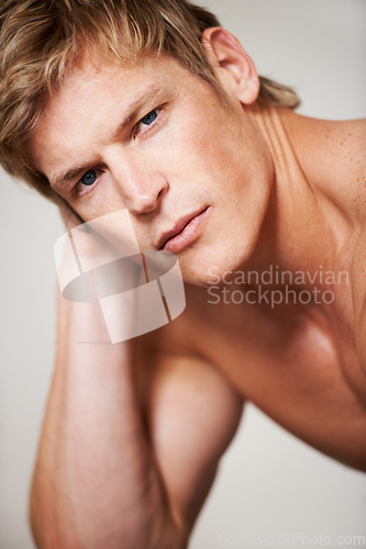 Image of Man, portrait and shirtless muscle in studio or white background for confident masculine, strong body or bodybuilder pride. Male person, model and face or topless or bicep arms, attractive or serious