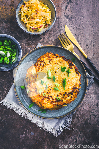 Image of Homemade hash browns or potato pancake with cabbage salad and green onions